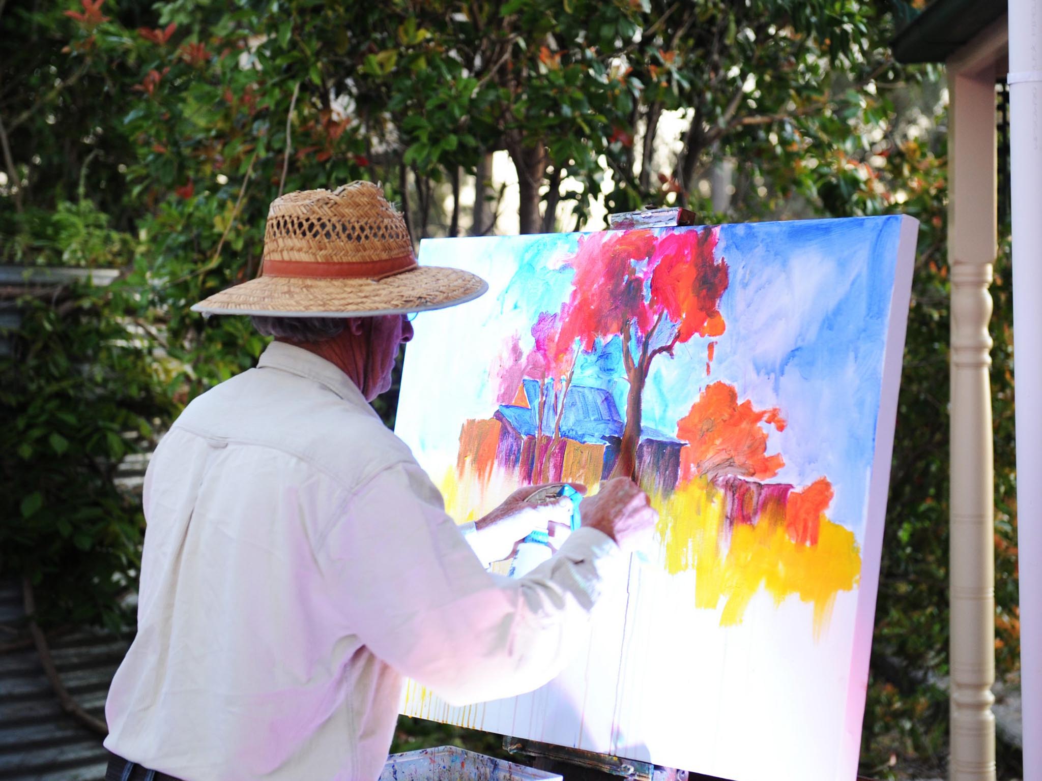 Artist painting a colourful landscape